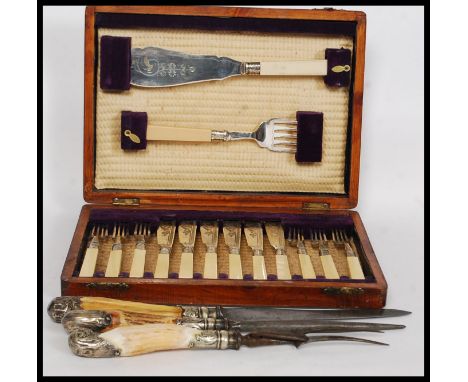 A cased Edwardian mahogany canteen of cutlery with fish knives together with a horn carving set being silver plated and an en