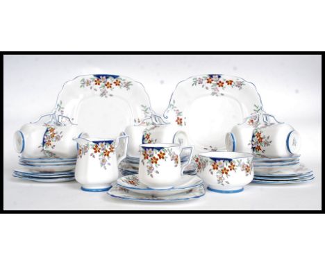 A stunning 1930's Art Deco handpainted part tea service in a chintz blue bell pattern  by Bell China. Comprising, cups, sauce