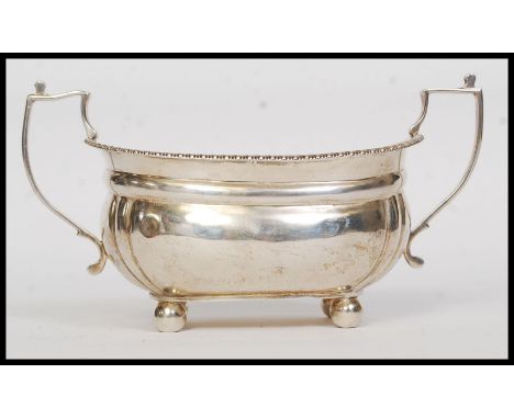 A solid silver twin handled large sugar bowl. Raised on ball finial feet with gadrooned borders and shaped handles. Hallmarke