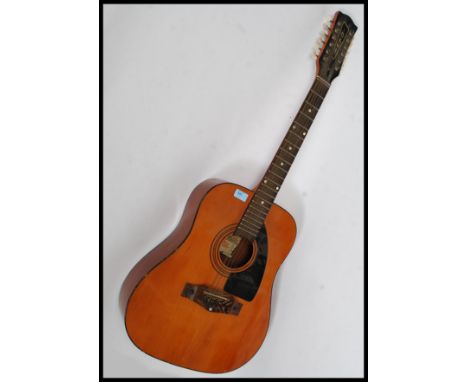 A vintage EKO 12 string acoustic guitar, with bone fret inlays and gilt EKO plaque to top. 