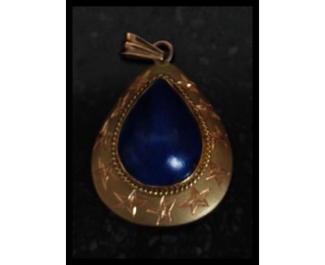 A 14ct gold Lapis Lazuli ladies pendant.  Of lozenge form having inset pear shaped form with chased gold surround. Total weig