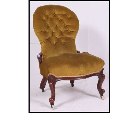 A Victorian mahogany spoon back ladies armchair / nursing chair. Raised on shaped legs with castors having a spoon shaped bac