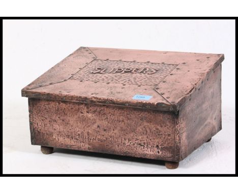 A hand beaten scratch built early Edwardian copper slipper box along with an oak arts and crafts chamber stick. 20x37x28cm
