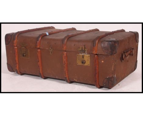 An excellent oversized large canvas and wooden bound early 20th century steamer trunk. Monogram W.E.T. to centre. 35x92x55cm