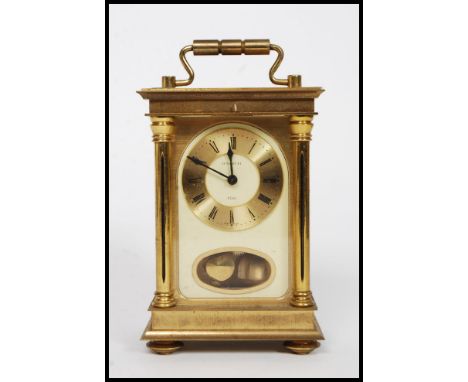 A good large H.Samuel brass 8 day carriage clock. The movement striking on a bell with pendulum window beneath dial. H18cm 