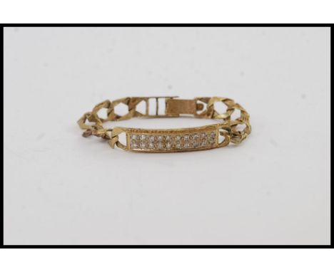 A 9ct gold kerb linked bracelet / bangle with bar being inset with low point stones approx 20 being 1pnt each. Total weight 8