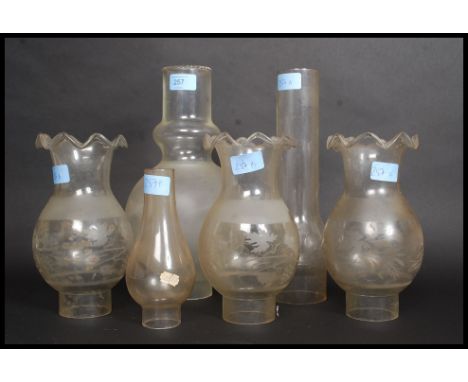 A collection of oil lamp shades to include a good frosted shade of unusual form and a matching set of 3 etc
