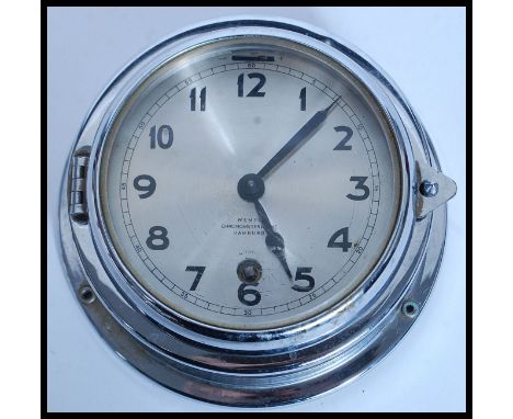 A mid century German ships bulkhead chronometer clock by WEMPE Hamburg. The chrome case with glass front and silvered dial.