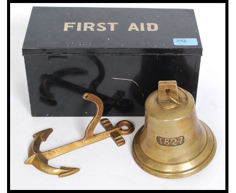 A vintage mid century first aid tin of pressed metal construction together with a brass wall bell attached to an anchor wall 