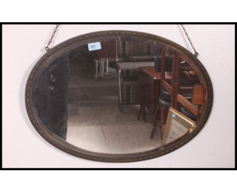 A 20th century brass surround wall mirror having a bevelled mirror panel. H44 x W61cm 