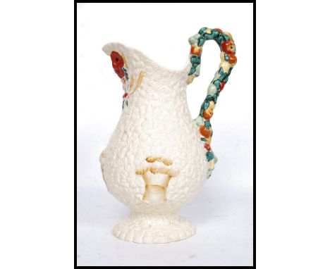 A large Clarice Cliff Celtic Harvest pattern jug of footed baluster form relief moulded with corn, fruit and foliage picked o