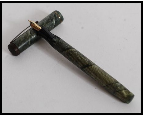 A vintage 20th century Mentmore Supremen Lever Fill Fountain Pen  having snakeskin effect cap and case. Mentmore 14k nib.

