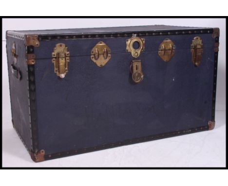 A vintage 20th century steamer trunk - suitcase chest. The heavy blue body being metal bound with central clasp. H51 x W92 x 