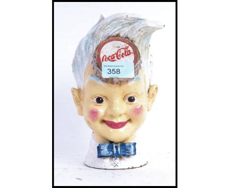A vintage style cast iron Coca Cola sprite money box, appearing to be hand painted with Cola lid to top. 