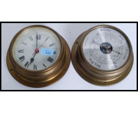 A contemporary vintage style brass effect bulkhead barometer together with matching quartz clock.