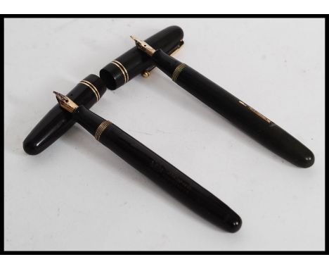 A vintage Swan Mabie Todd Ltd self filler  fountain pen with 14ct gold nib in black with gold trim ( 3261) . Together with an