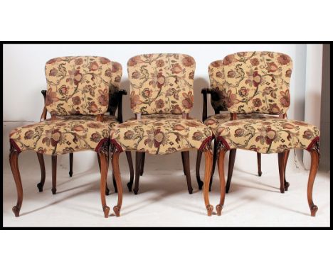 A French 20th century style set of 6 fauteuil dining chairs. Raised on cabriole legs with carved shoulders. Tapestry upholste