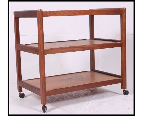 An excellent 1970's Danish teak buffet - serving butlers trolley. The squared uprights with central tiers, all on original ca