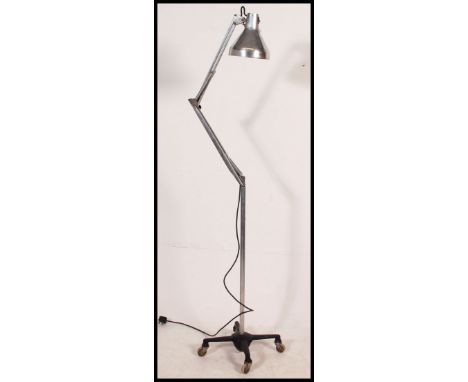 A large polished metal Herbert Terry anglepoise Industrial floor standing anglepoise lamp set over quadruped castor base. Pen