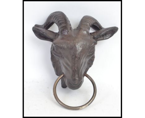 A goat head exterior metal dog leash holder / horse tie. Hand painted. 