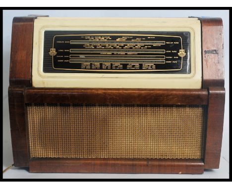 A vintage 1950's table top wooden cased radiogram by Regetone, having a lift up front to reveal record deck, speaker to the f
