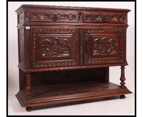 A 19th century Jacobean carved oak green man revival marble top sideboard / buffet. The veined marble top raised on column su