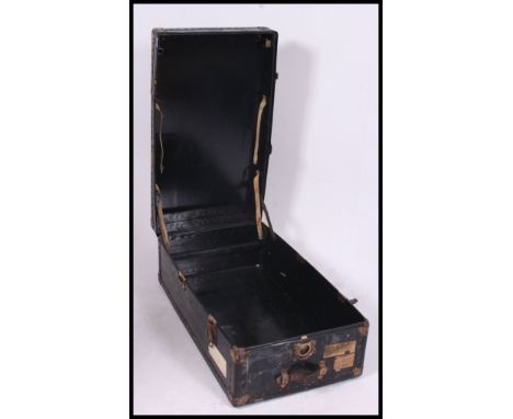 A mid 20th century steamer trunk unusually opening from one end complete with clasps