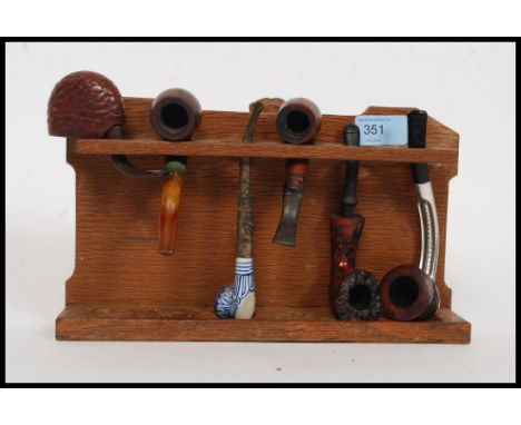 A believed Peter ' Rabbitman ' Heap carved oak pipe rack, with carved rabbit to centre top, along with a selection of assorte