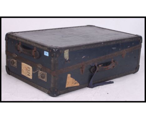 A vintage early 20th century travel trunk, having a hinged lid, travel labels, lined interior,  ideal for a coffee table. 27x