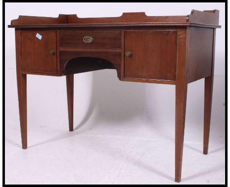 An Edwardian mahogany writing table desk. Raised on tapered supports with locker cupboard and drawer over the central kneehol