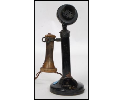 A vintage metal and bakelite stick telephone. The earpiece of vulcanite form with original flex. Metal base with dial af. H34