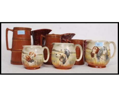 A collection of graduating jugs by British Anchor each with dog - hunting scenes. Also a set of 3 German graduating vase and 