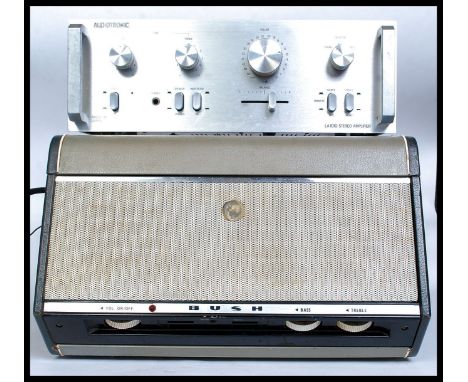A vintage two tone portable Bush record player with hinged top and inset Monarch deck. Together with an audiotronic LA 1010 s