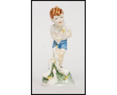 A Royal Worcester porcelain Doughty figure, Young Farmer, of a boy with ducklings, 17.5cm
