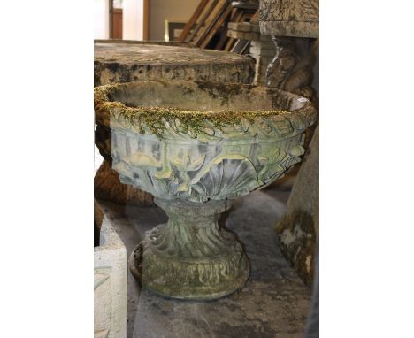 A CIRCULAR GARDEN PLANTER WITH FLORAL DETAIL
