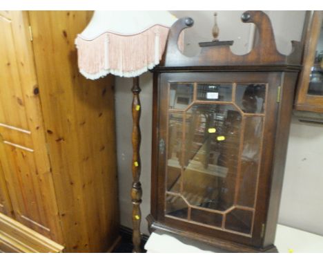 A MODERN HANGING CORNER CABINET AND A STANDARD LAMP (2)