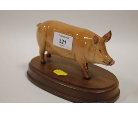 A ROYAL DOULTON PIG FIGURE ON PLINTH