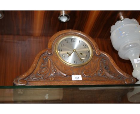 A VINTAGE CARVED OAK MANTLE CLOCK 