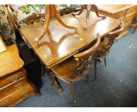 AN ERCOL OAK DRAWLEAF TABLE AND FOUR CHAIRS