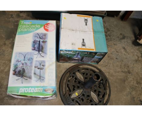 A TREE CASCADE PLANTER PARASOL BASE TOGETHER WITH A BOXED CHIMINEA 