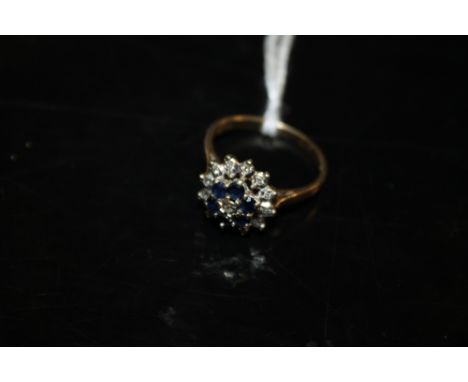 A 9CT GOLD SAPPHIRE AND DIAMOND CLUSTER RING