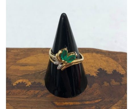 A 10k emerald and diamond ring