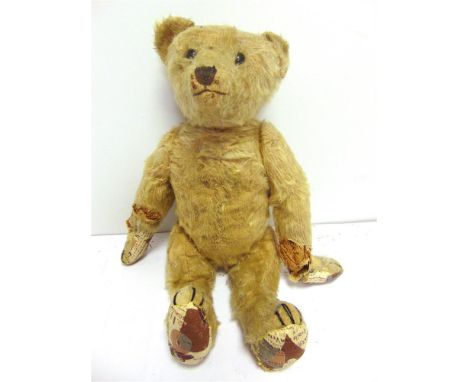 A BLONDE MOHAIR TEDDY BEAR circa 1920, possibly by Steiff, with boot button eyes and a black vertically stitched nose, on a j