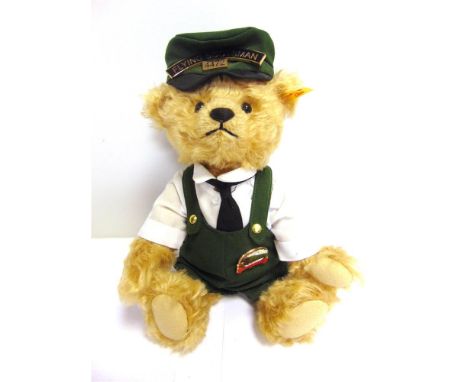 A STEIFF COLLECTOR'S TEDDY BEAR 'BILL', THE FLYING SCOTSMAN (EAN 664694), gold, dressed as a locomotive driver, 26cm high, un