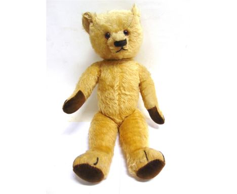 A GOLD MOHAIR TEDDY BEAR mid 20th century, with orange glass eyes, a dark brown horizontally stitched nose, and brown velvet 