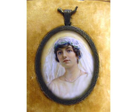 A PORTRAIT MINIATURE OF A YOUNG BRIDE circa 1910, watercolour, unsigned, 5cm x 4cm (oval), framed and glazed, in a fitted lea