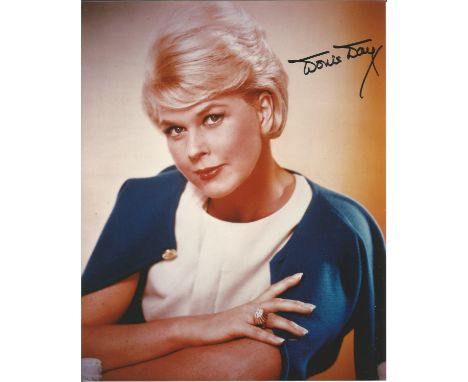 Actress Doris Day signed stunning 10 x 8 inch colour 3/4 length portrait photo. Good condition. All autographs come with a Ce