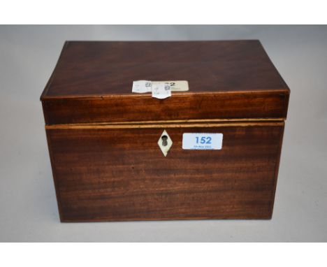 A Georgian tea caddy of plain form with mahogany case lion head handles and inlayed detail.