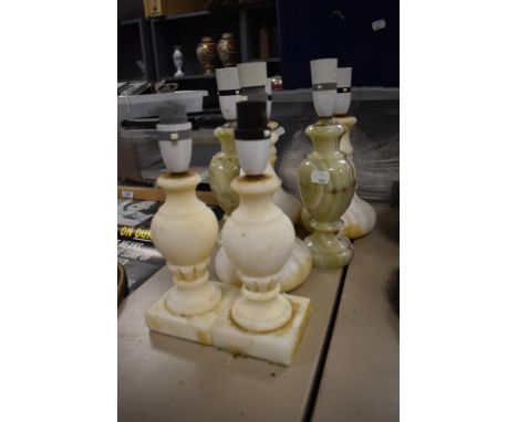 Two vintage onyx stone cut lamp bases with five white alabaster lamps.