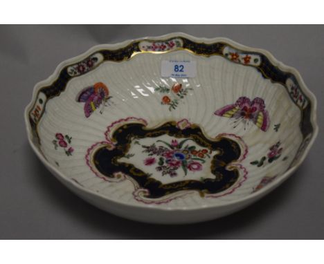 A first period Worcester bowl having scalloped form with butterfly and moth decoration. Having been restored. 26cm wide. with